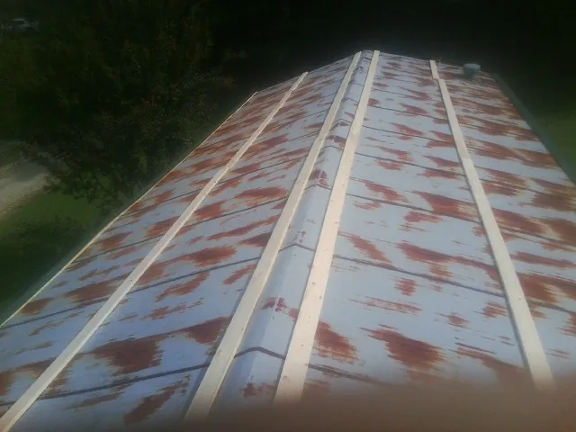 Rusted metal roof panels with new wood purlins before replacement — Storm Damage Roof Repair in Pompey by Roofing Brothers